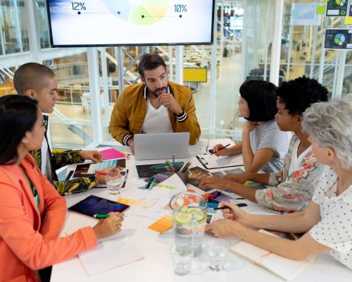 High angle view of diverse business people discussing in the meeting at conference room in office